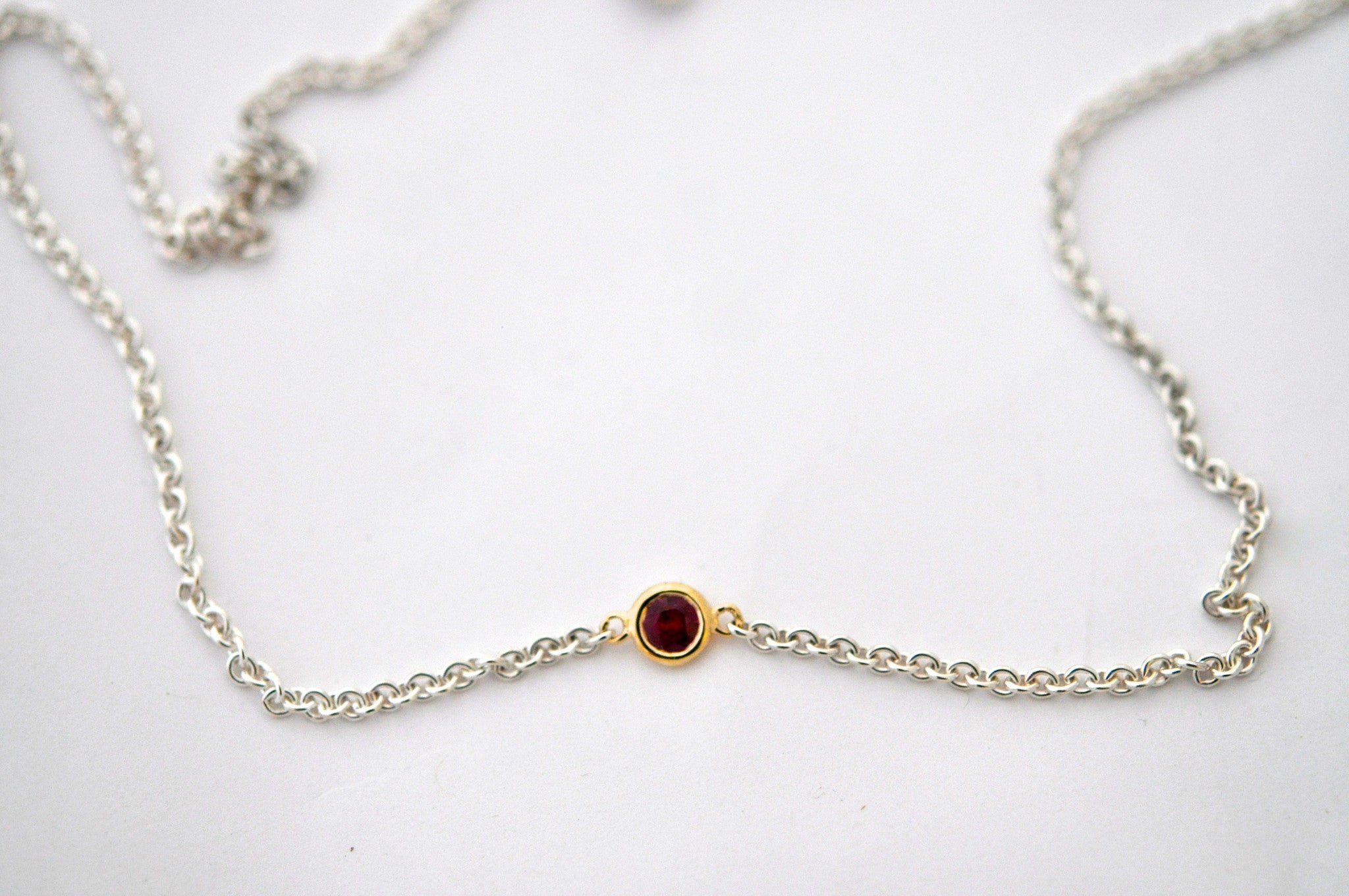 necklace / silver + small gemstone in gold bezel