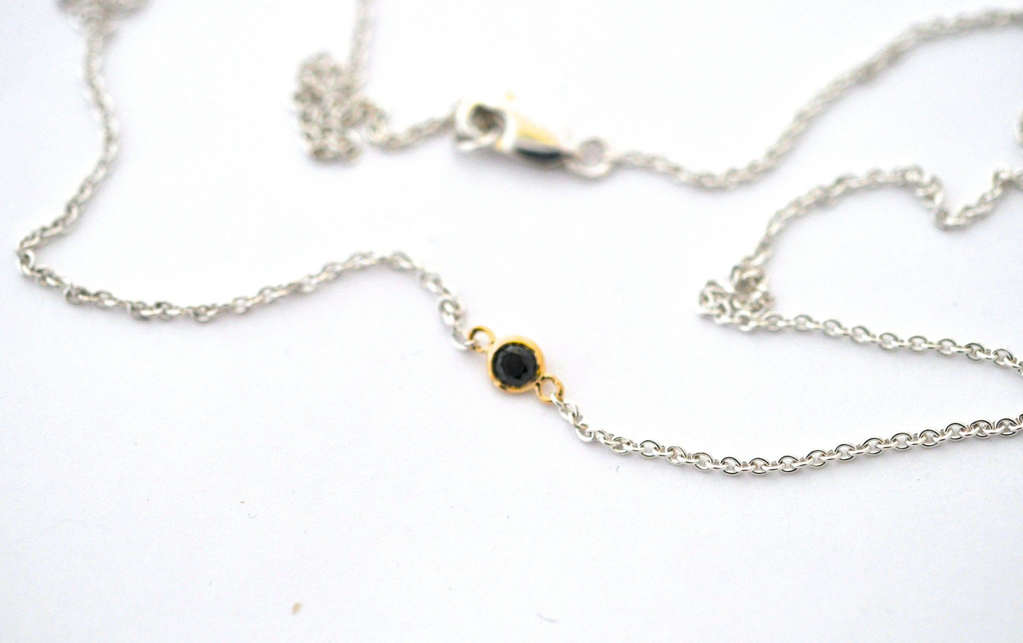 necklace / silver + small gemstone in gold bezel